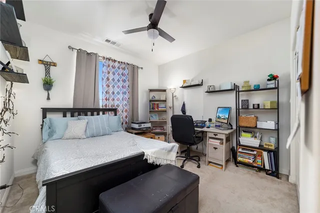 a living room with furniture and a book shelf
