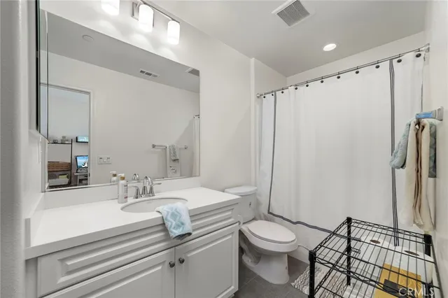 a bathroom with a double vanity sink toilet and shower