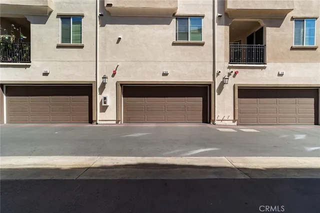 a front view of a house with a parking space
