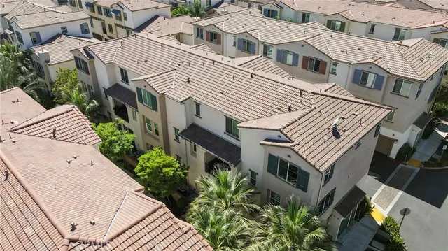 an aerial view of a house with a yard and potted plants