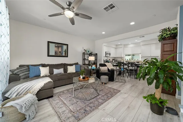 a living room with furniture potted plant and a window