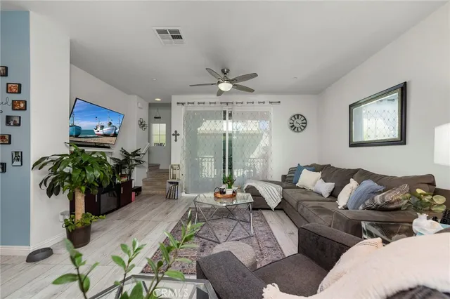 a living room with furniture potted plant and a chandelier