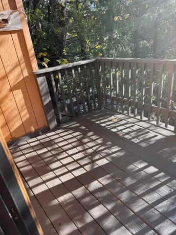 a view of a balcony with wooden floor