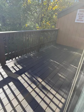 a view of a balcony with wooden floor