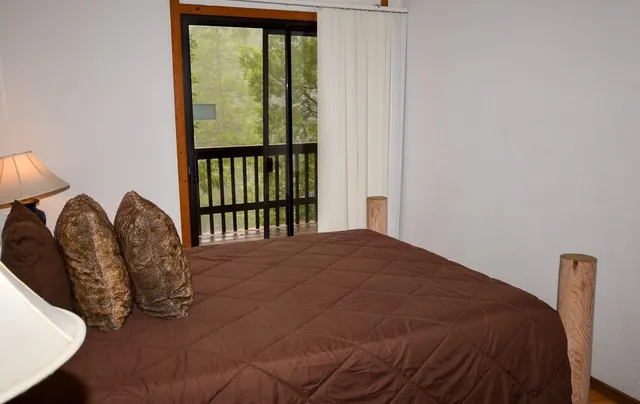 a bed sitting in a bedroom next to a window