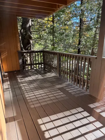 a balcony with next to a brick wall