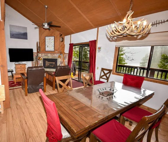 a living room with furniture a flat screen tv and a chandelier