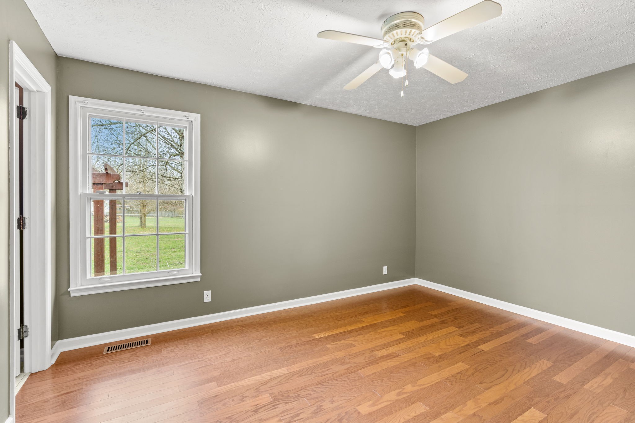 108 Meadows Road White House, TN 37188 - Photo 11 of 27 an empty room with a window and a fan