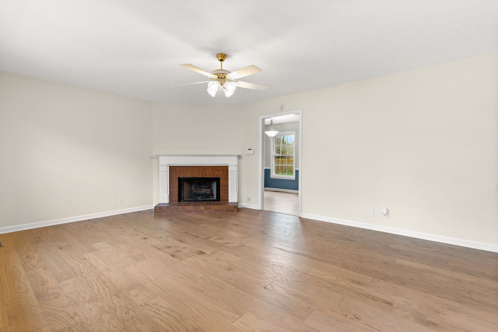 108 Meadows Road White House, TN 37188 - Photo 3 of 27 a view of empty room with wooden floor and fireplace