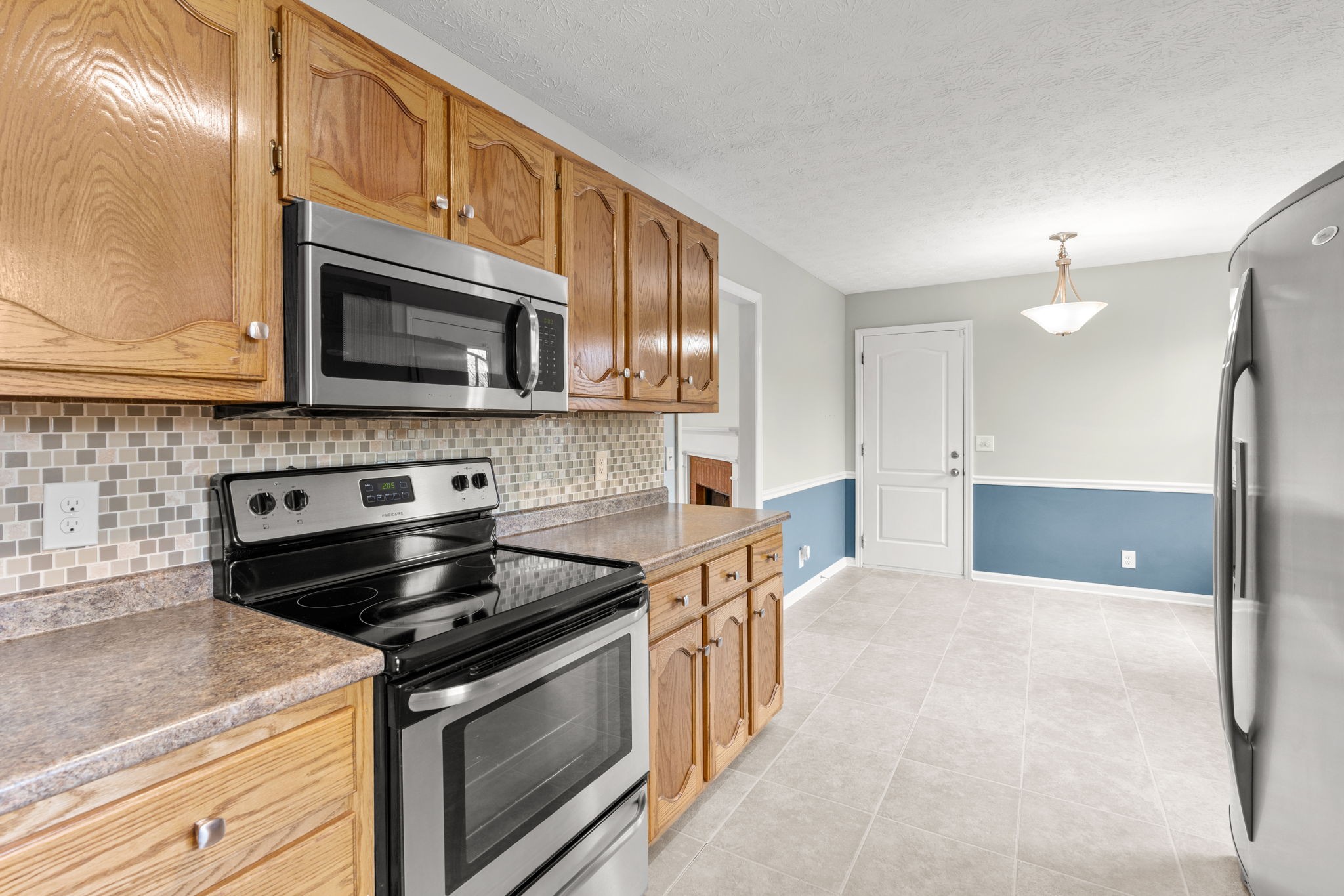 108 Meadows Road White House, TN 37188 - Photo 6 of 27 a kitchen with stainless steel appliances a stove a microwave and cabinets