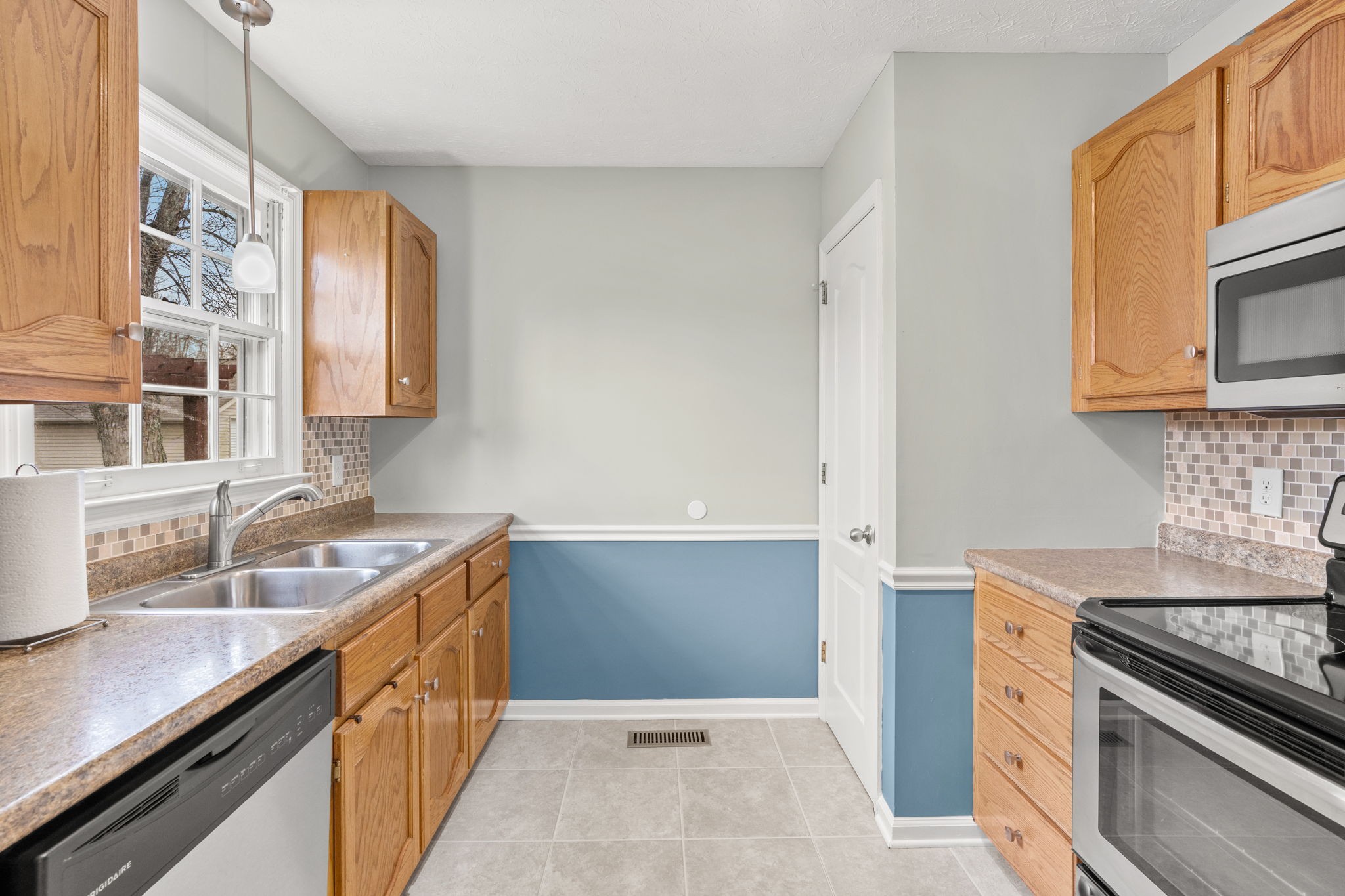 108 Meadows Road White House, TN 37188 - Photo 7 of 27 a kitchen with a sink stove top oven and cabinets