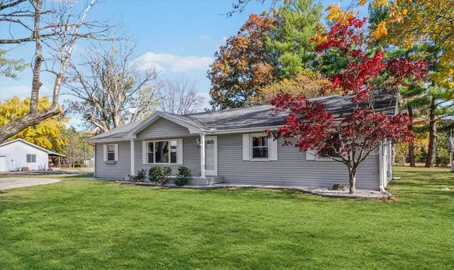 a front view of house with yard and green space