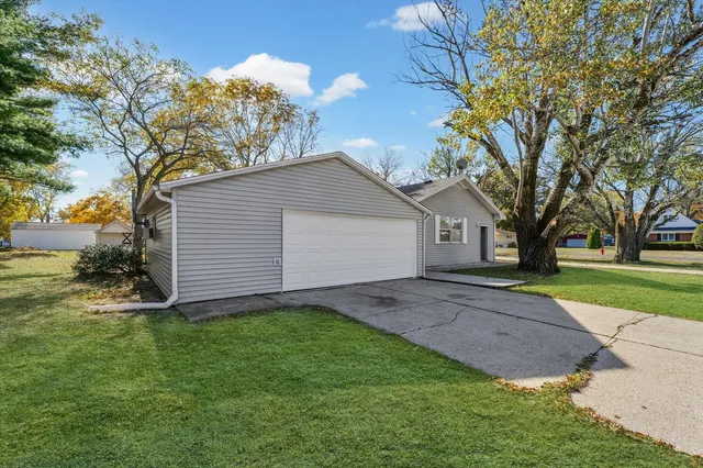 a view of a yard with a house and a large tree
