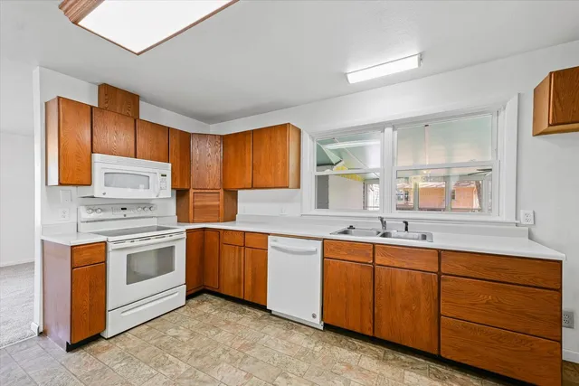 a kitchen with appliances cabinets and a sink