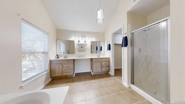 a large kitchen with a window and refrigerator