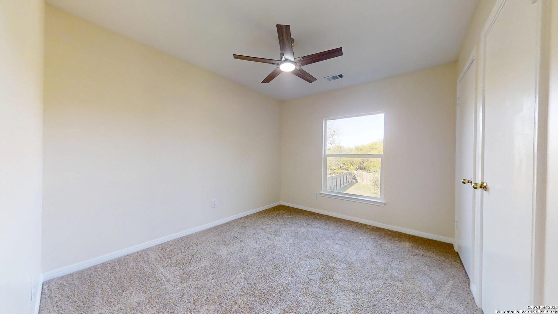 10718 Mustang Ridge Converse, TX 78109 - Photo 18 of 21 an empty room with a window and a fan