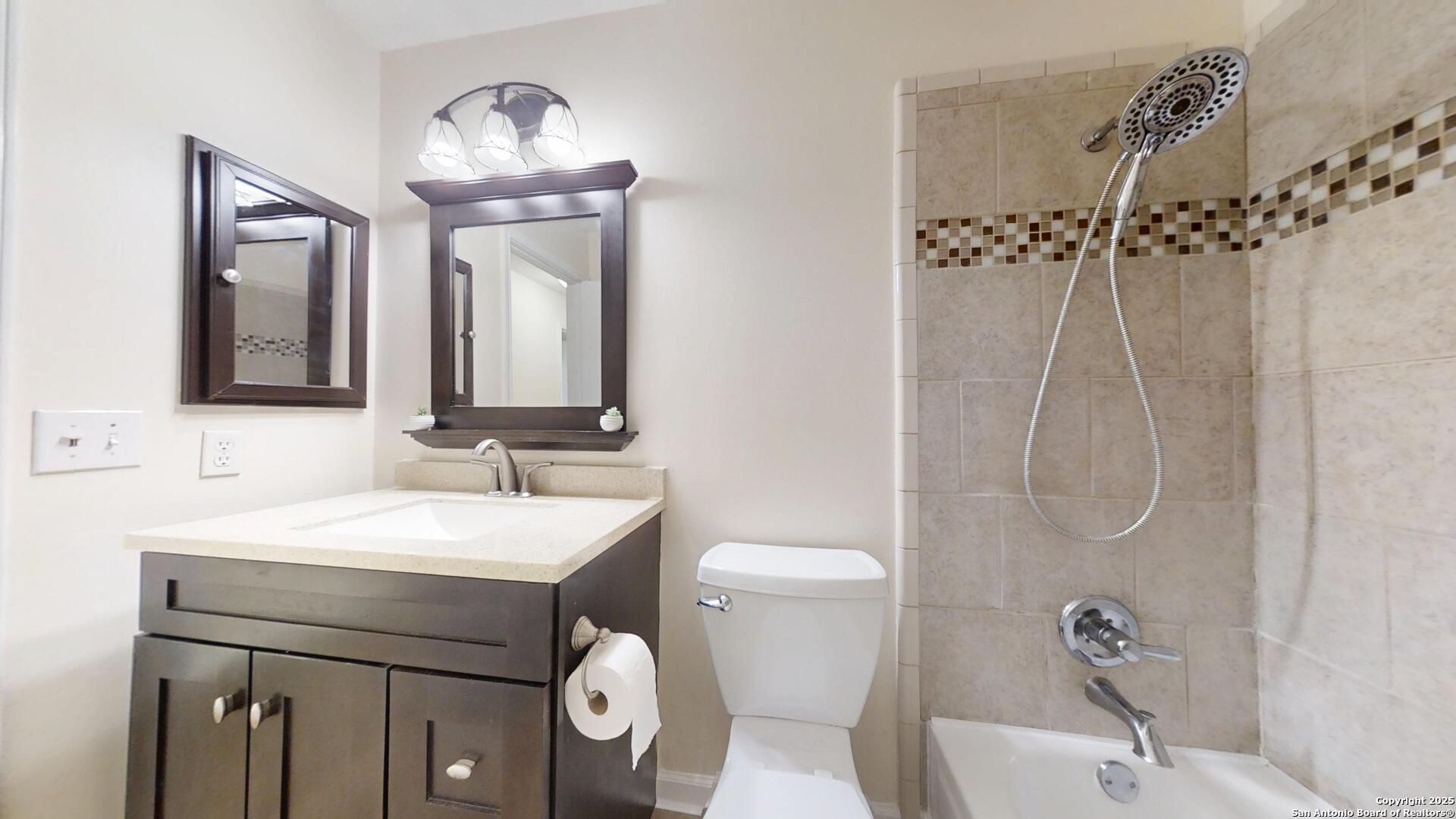 10718 Mustang Ridge Converse, TX 78109 - Photo 20 of 21 a bathroom with a sink and a mirror