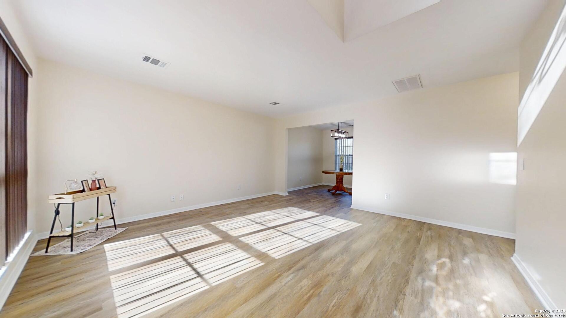10718 Mustang Ridge Converse, TX 78109 - Photo 3 of 21 a view of wooden floor and windows in a room