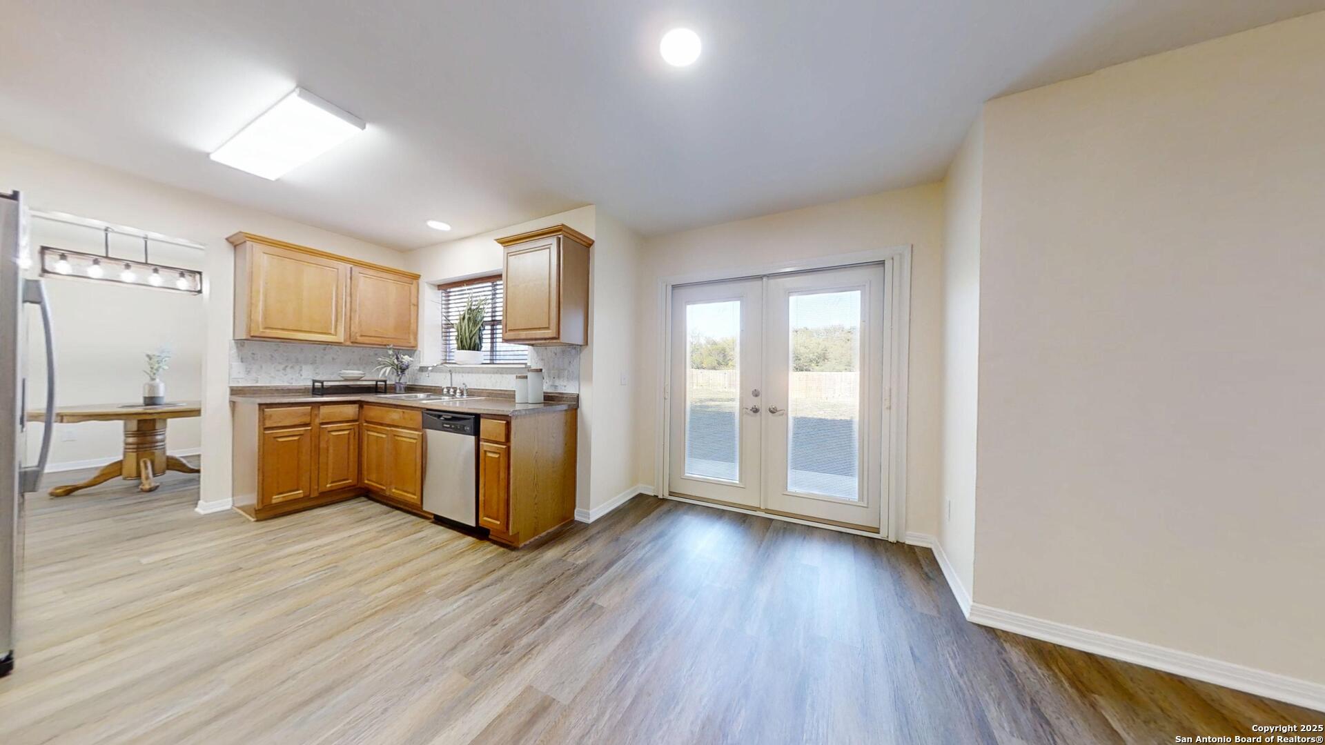 10718 Mustang Ridge Converse, TX 78109 - Photo 5 of 21 a kitchen with granite countertop a stove top oven and cabinets