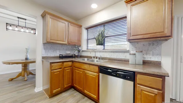 a kitchen with stainless steel appliances granite countertop a sink stove and cabinets