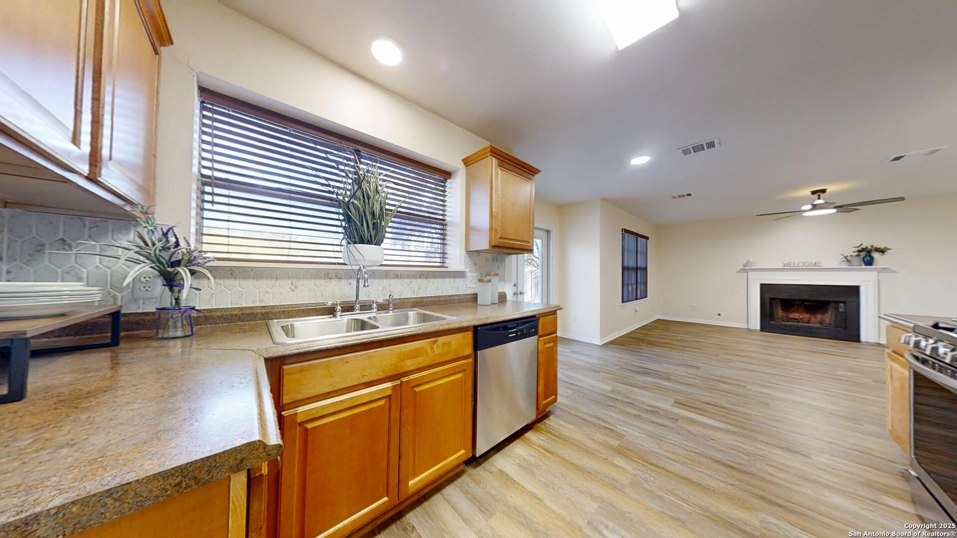 10718 Mustang Ridge Converse, TX 78109 - Photo 8 of 21 a kitchen with stainless steel appliances granite countertop a sink stove and wooden floor