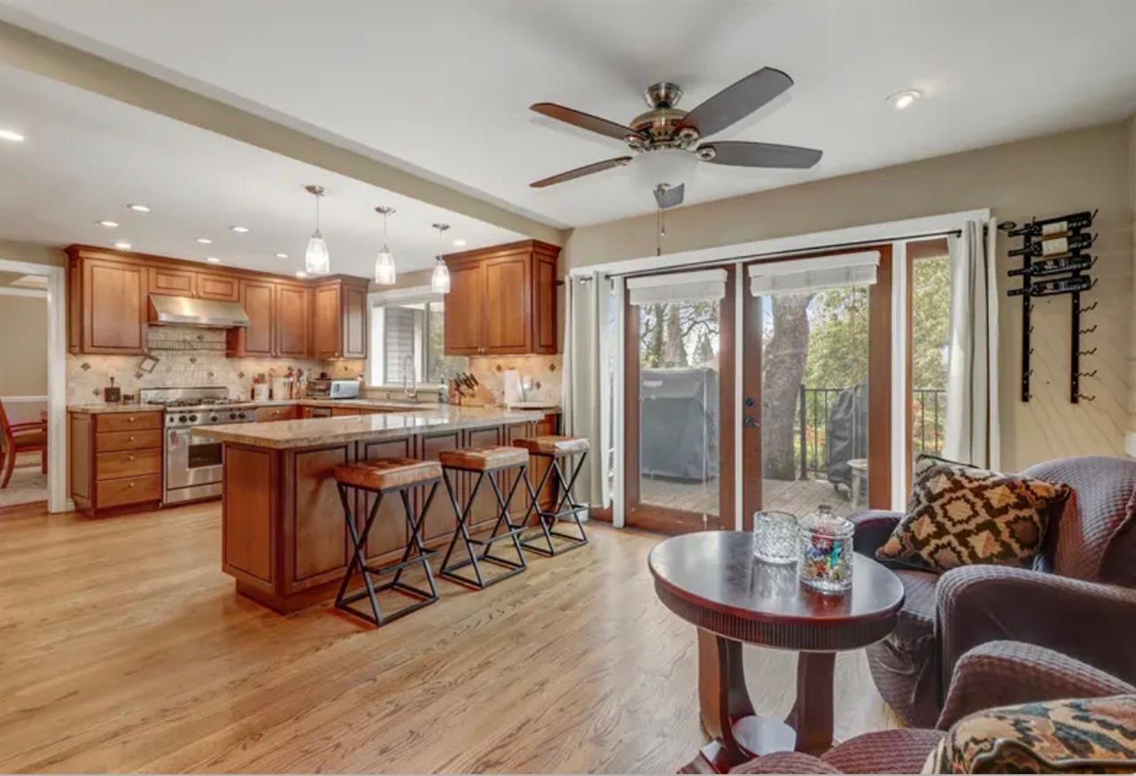 15044 Rio Circle Rancho Murieta, CA 95683 - Photo 16 of 50 a living room with stainless steel appliances kitchen island granite countertop furniture and a view of kitchen