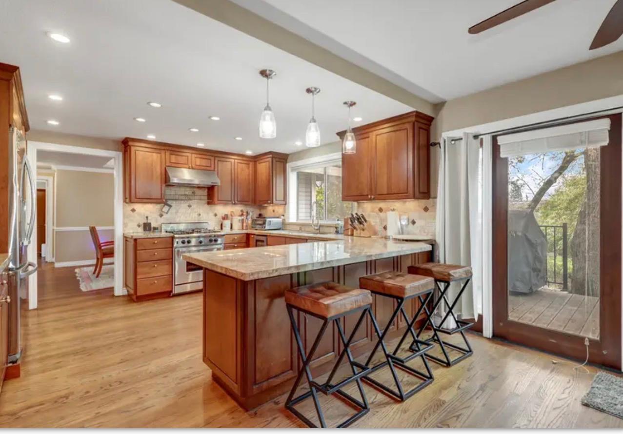 15044 Rio Circle Rancho Murieta, CA 95683 - Photo 17 of 50 a kitchen with stainless steel appliances granite countertop table chairs sink and cabinets