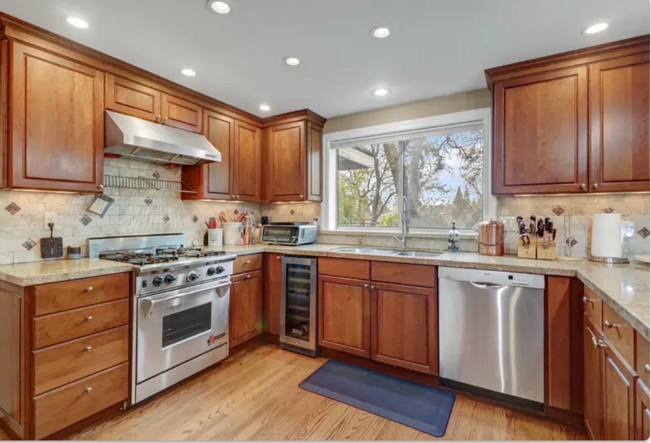15044 Rio Circle Rancho Murieta, CA 95683 - Photo 18 of 50 a kitchen with stainless steel appliances granite countertop a stove sink and cabinets