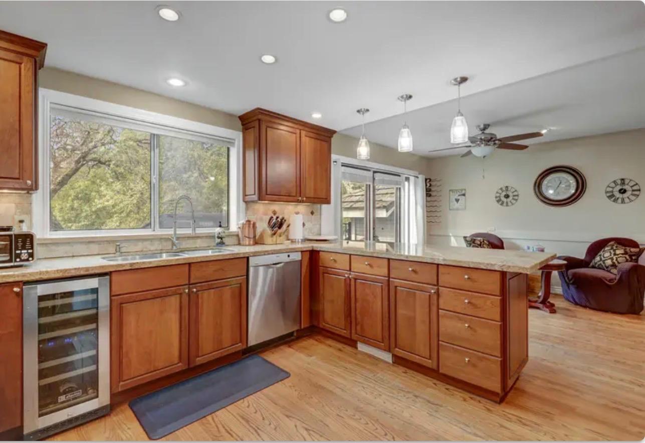 15044 Rio Circle Rancho Murieta, CA 95683 - Photo 19 of 50 a large kitchen with stainless steel appliances granite countertop a sink and wooden cabinets