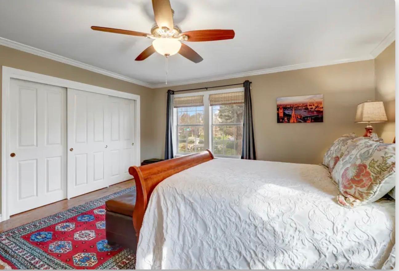 15044 Rio Circle Rancho Murieta, CA 95683 - Photo 24 of 50 a bedroom with a bed and a chandelier