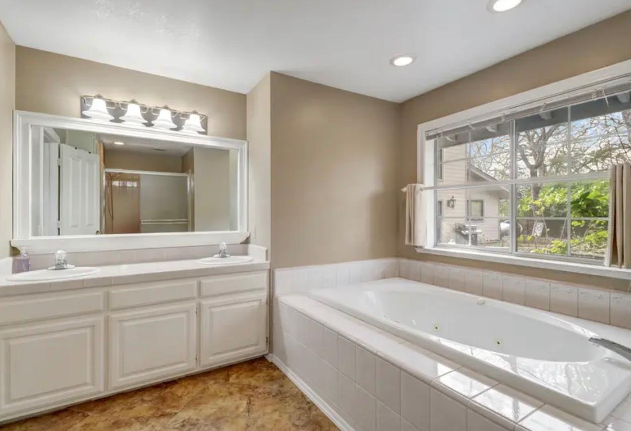 15044 Rio Circle Rancho Murieta, CA 95683 - Photo 26 of 50 a bathroom with a tub a sink and a window