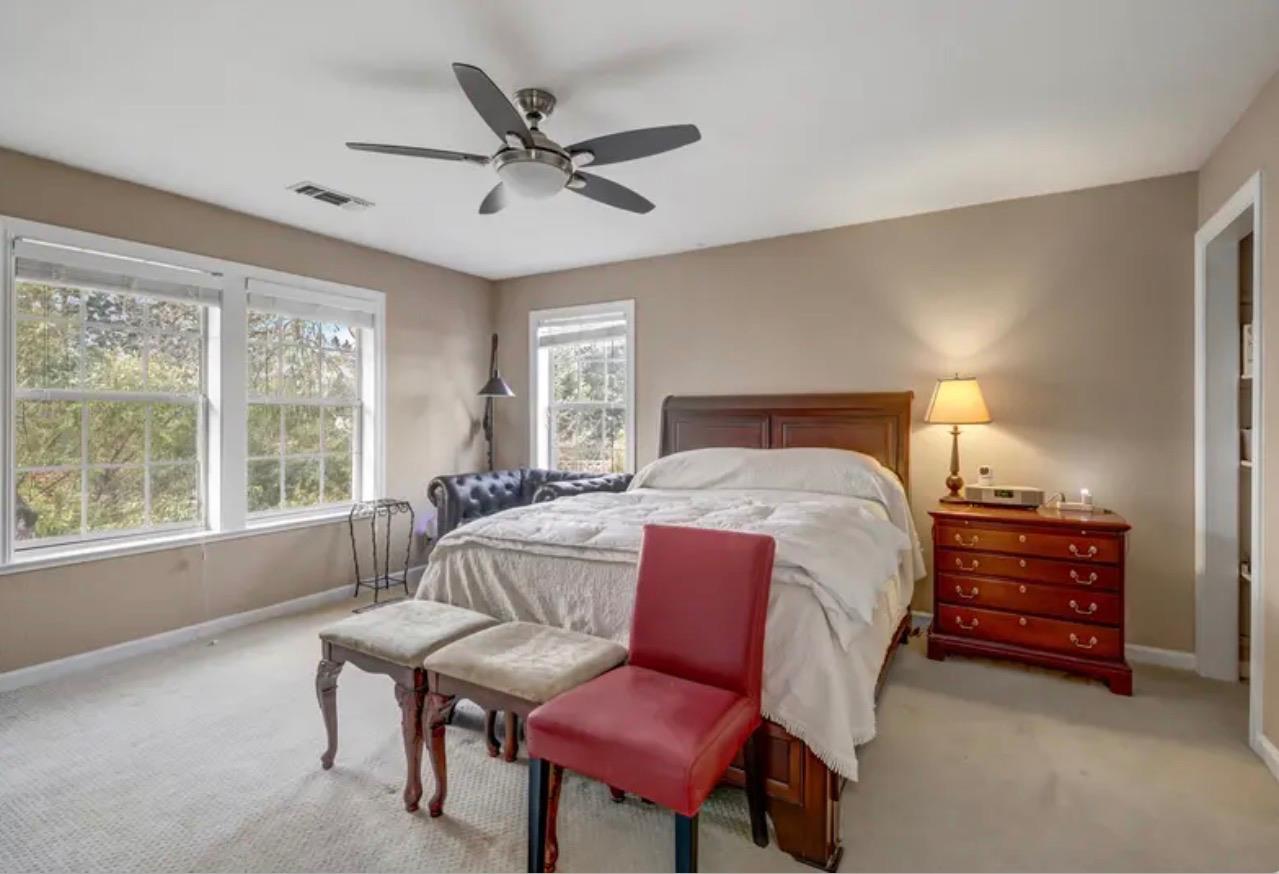 15044 Rio Circle Rancho Murieta, CA 95683 - Photo 31 of 50 a spacious bedroom with a bed a couch and a window