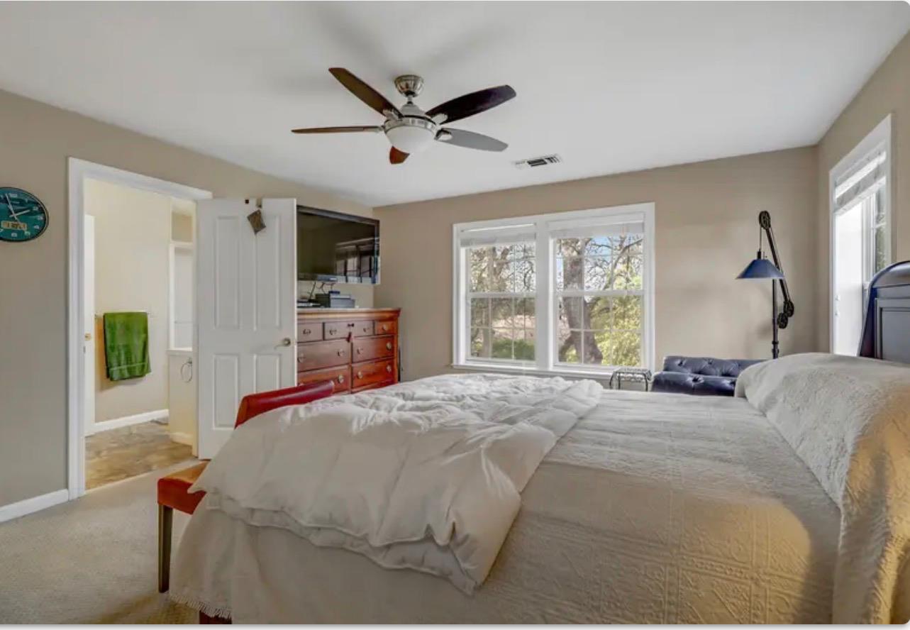 15044 Rio Circle Rancho Murieta, CA 95683 - Photo 33 of 50 a bed room with a bed and a large window