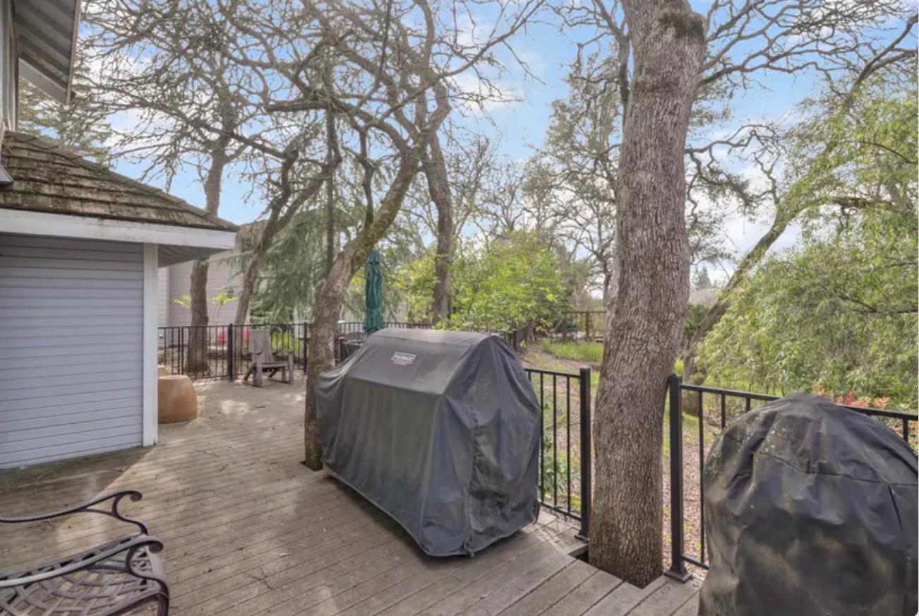 15044 Rio Circle Rancho Murieta, CA 95683 - Photo 42 of 50 a view of backyard with large trees and wooden fence