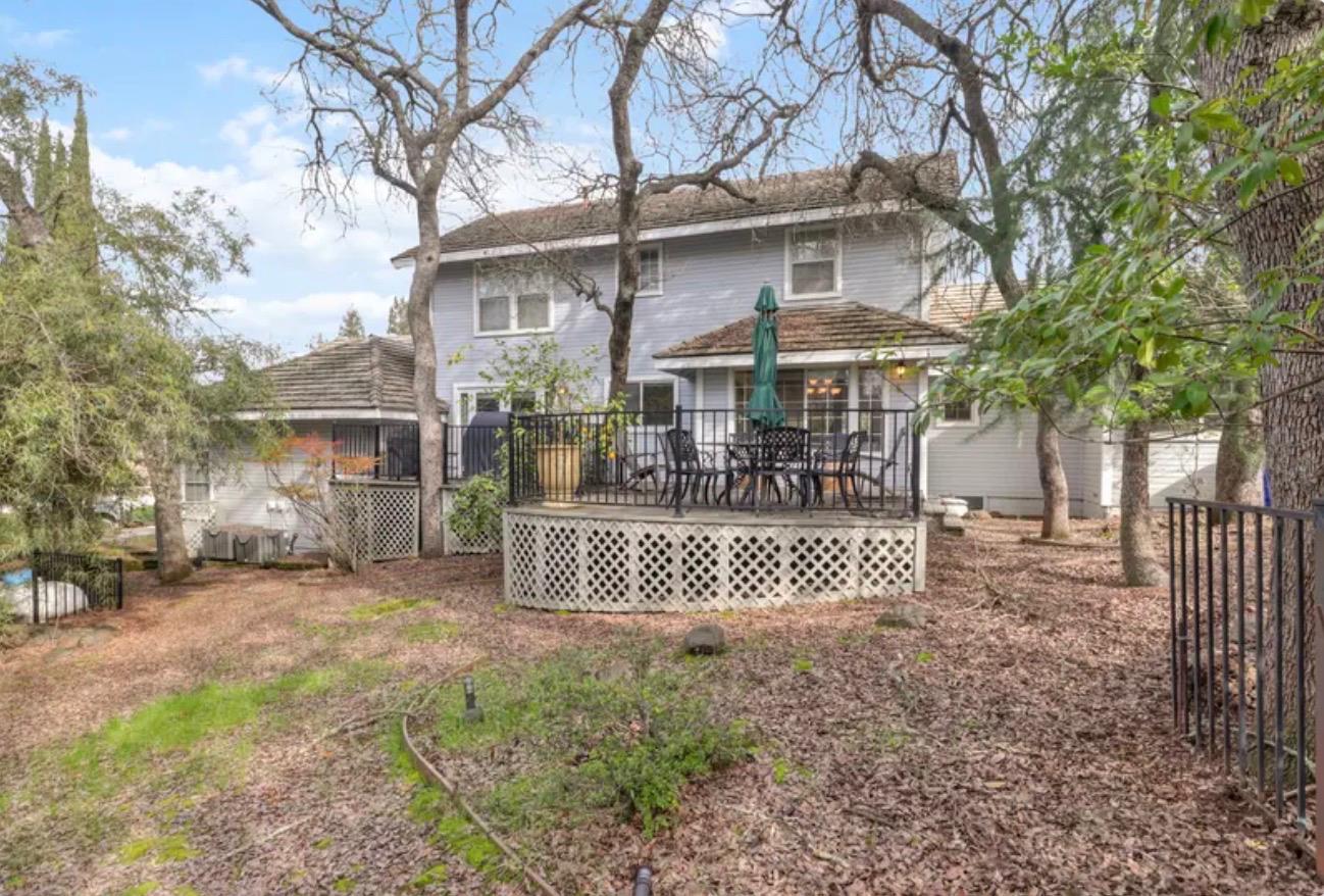 15044 Rio Circle Rancho Murieta, CA 95683 - Photo 45 of 50 a front view of a house with a garden and trees