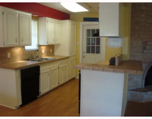 a kitchen with cabinets and window