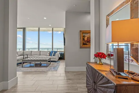 a living room with furniture and a floor to ceiling window
