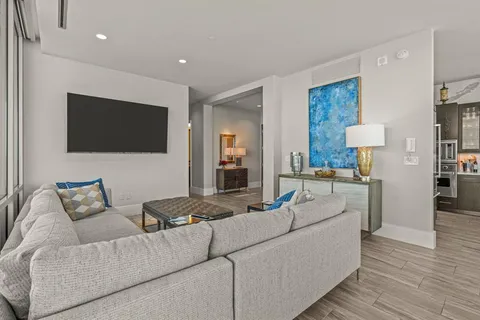 a kitchen with stainless steel appliances kitchen island granite countertop a refrigerator and a dining table