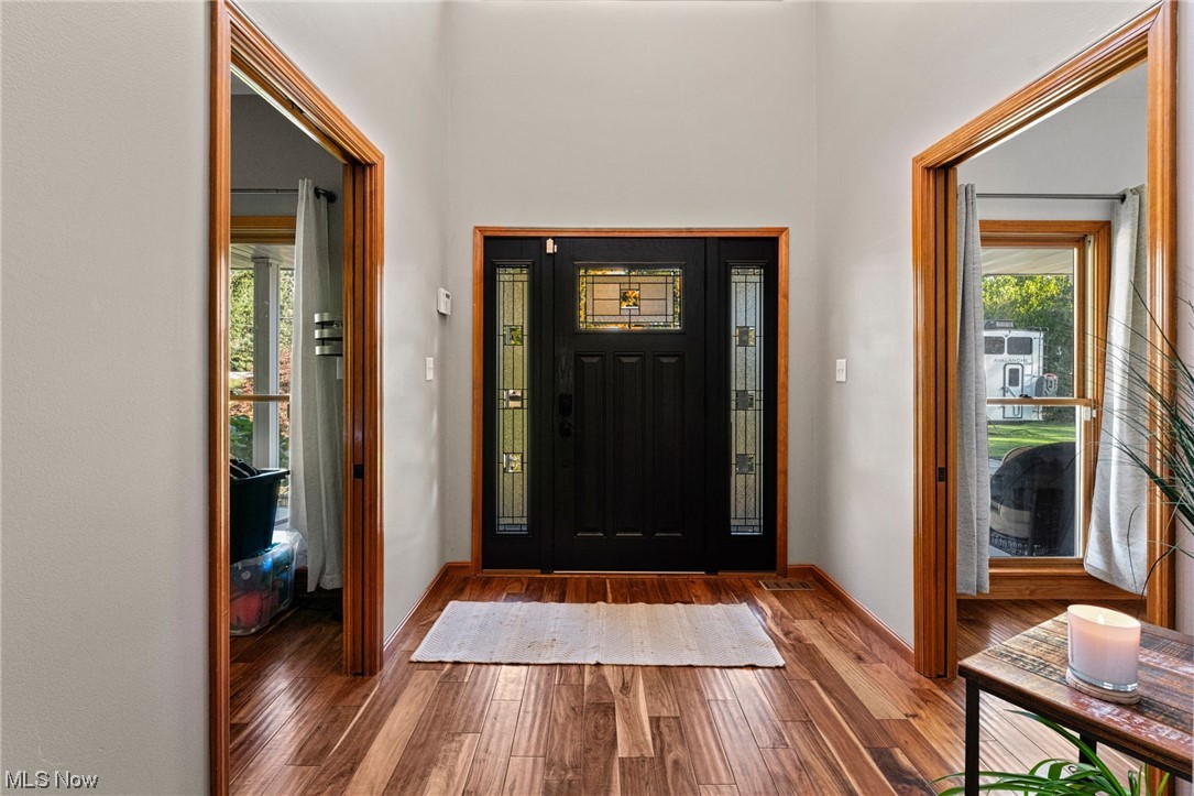 7534 Rice Road Amherst, OH 44001 - Photo 10 of 35 Foyer with plenty of natural light and dark hardwood / wood-style flooring