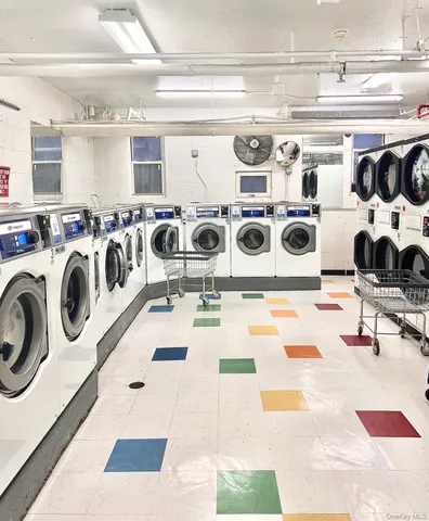 a living room with a washing machine and bicycles