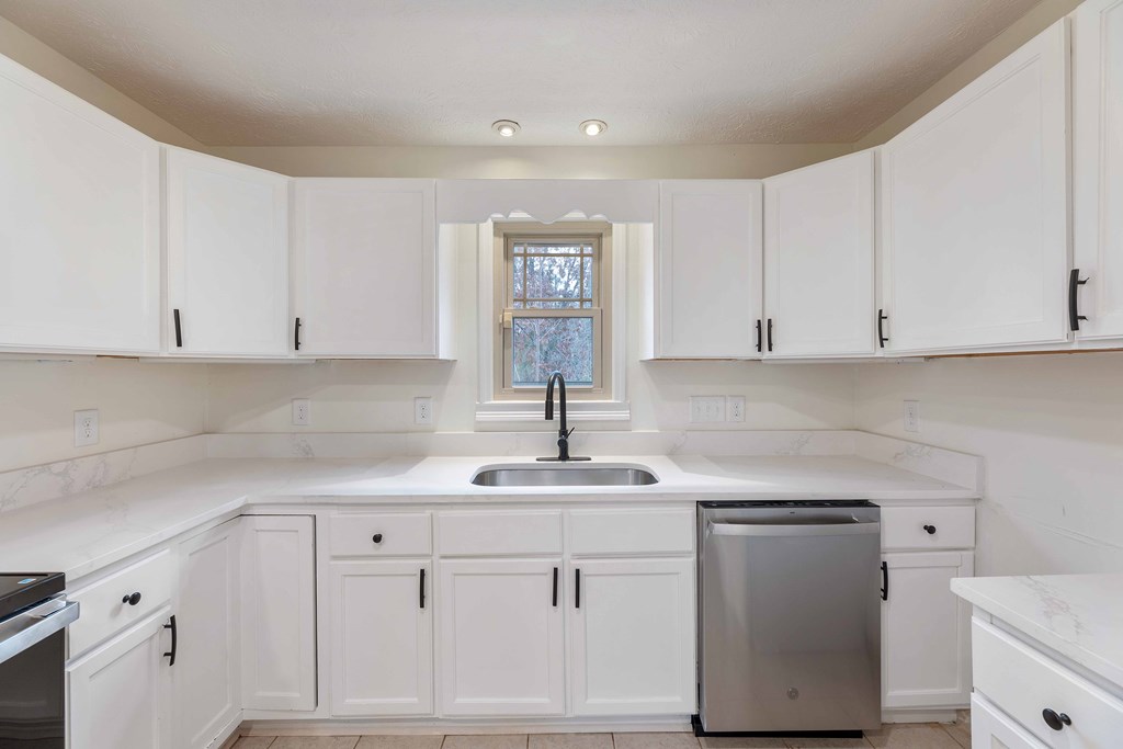 322 Moores Chapel Road Mauk, GA 31058 - Photo 11 of 34 a kitchen with white cabinets sink and dishwasher
