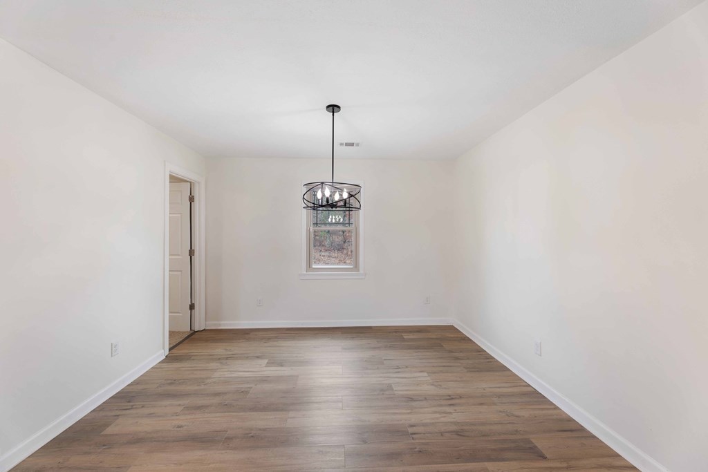 322 Moores Chapel Road Mauk, GA 31058 - Photo 12 of 34 an empty room with wooden floor and windows