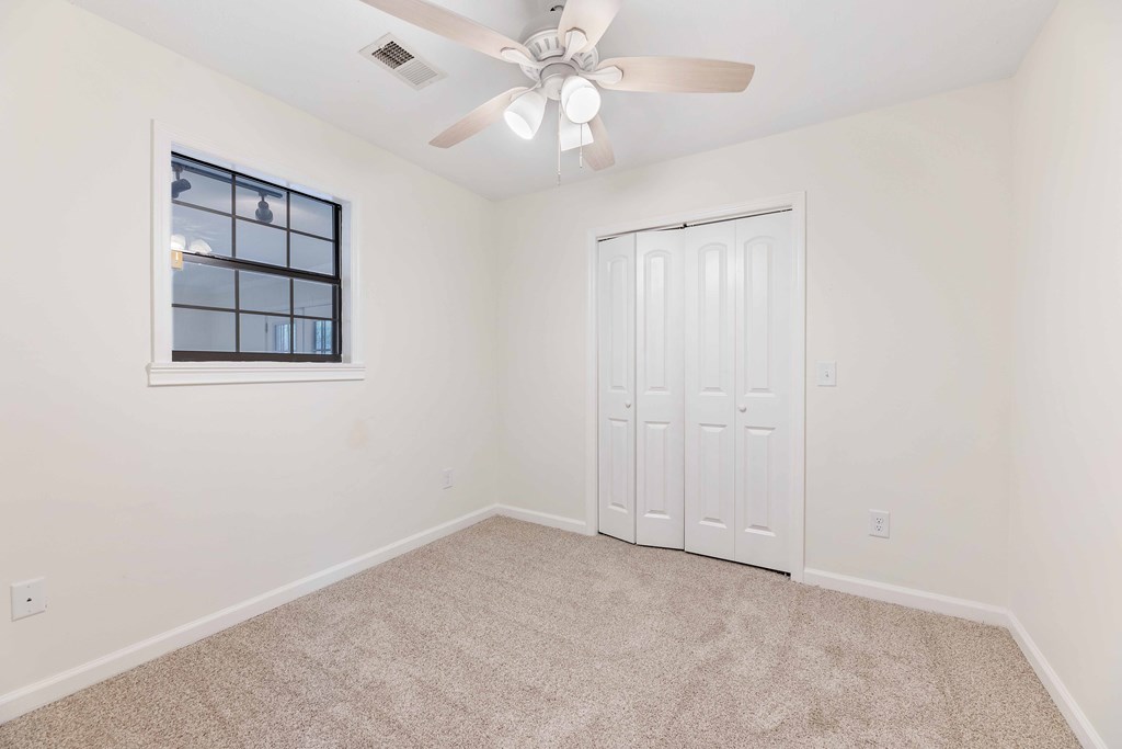 322 Moores Chapel Road Mauk, GA 31058 - Photo 17 of 34 an empty room with windows and fan