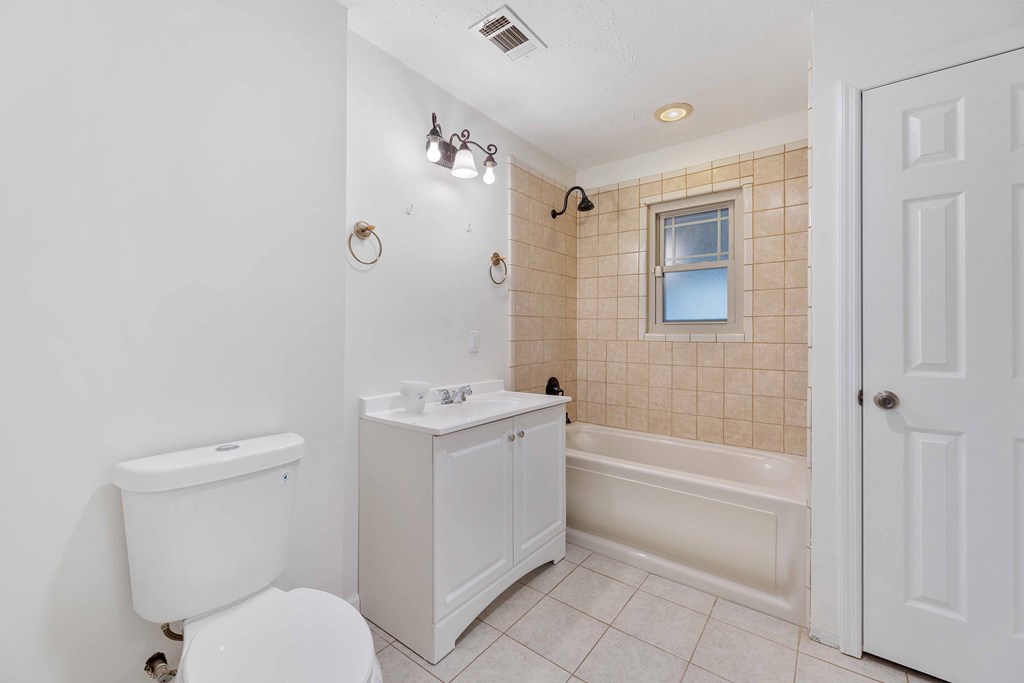 322 Moores Chapel Road Mauk, GA 31058 - Photo 18 of 34 a bathroom with a granite countertop toilet a sink and bathtub