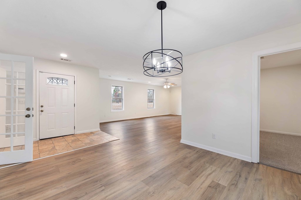 322 Moores Chapel Road Mauk, GA 31058 - Photo 2 of 34 a view of an empty room with wooden floor and chandelier