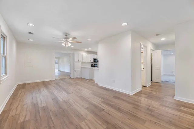 a view of a kitchen with a sink and a refrigerator