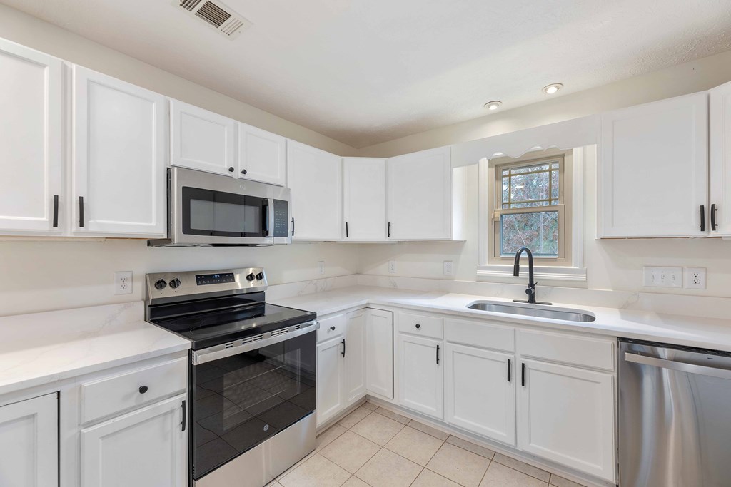 322 Moores Chapel Road Mauk, GA 31058 - Photo 8 of 34 a kitchen with white cabinets sink and white appliances