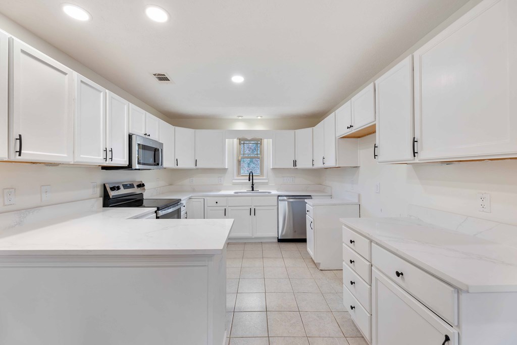 322 Moores Chapel Road Mauk, GA 31058 - Photo 10 of 34 a kitchen with cabinets appliances a sink and a counter top