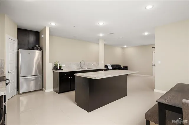 a kitchen with stainless steel appliances a refrigerator and a sink