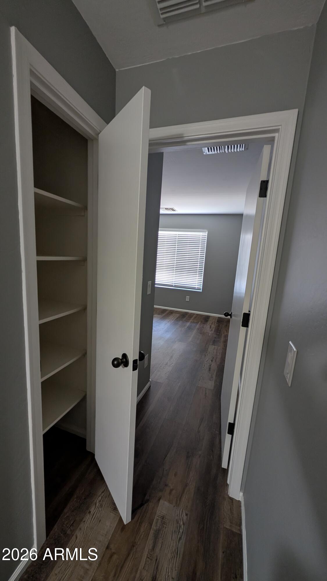 1377 East Pryor Road San Tan Valley, AZ 85140 - Photo 17 of 31 a view of a hallway with wooden floor and closet